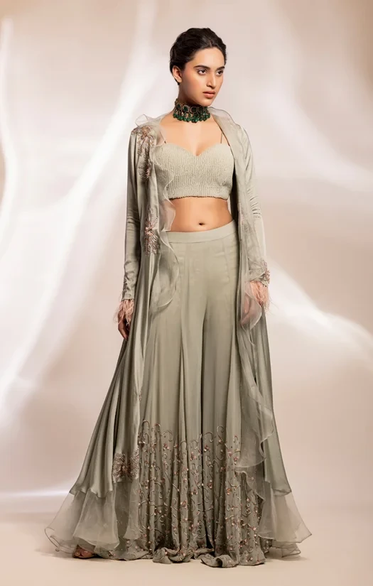 Long asymmetrical jacket , worn over corset and sharara pants